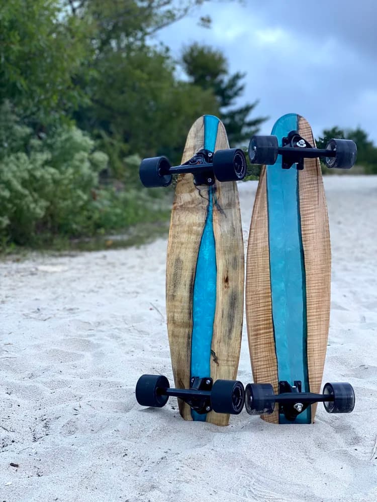 Classic Fishtail Cruiser longboard on white sand beach