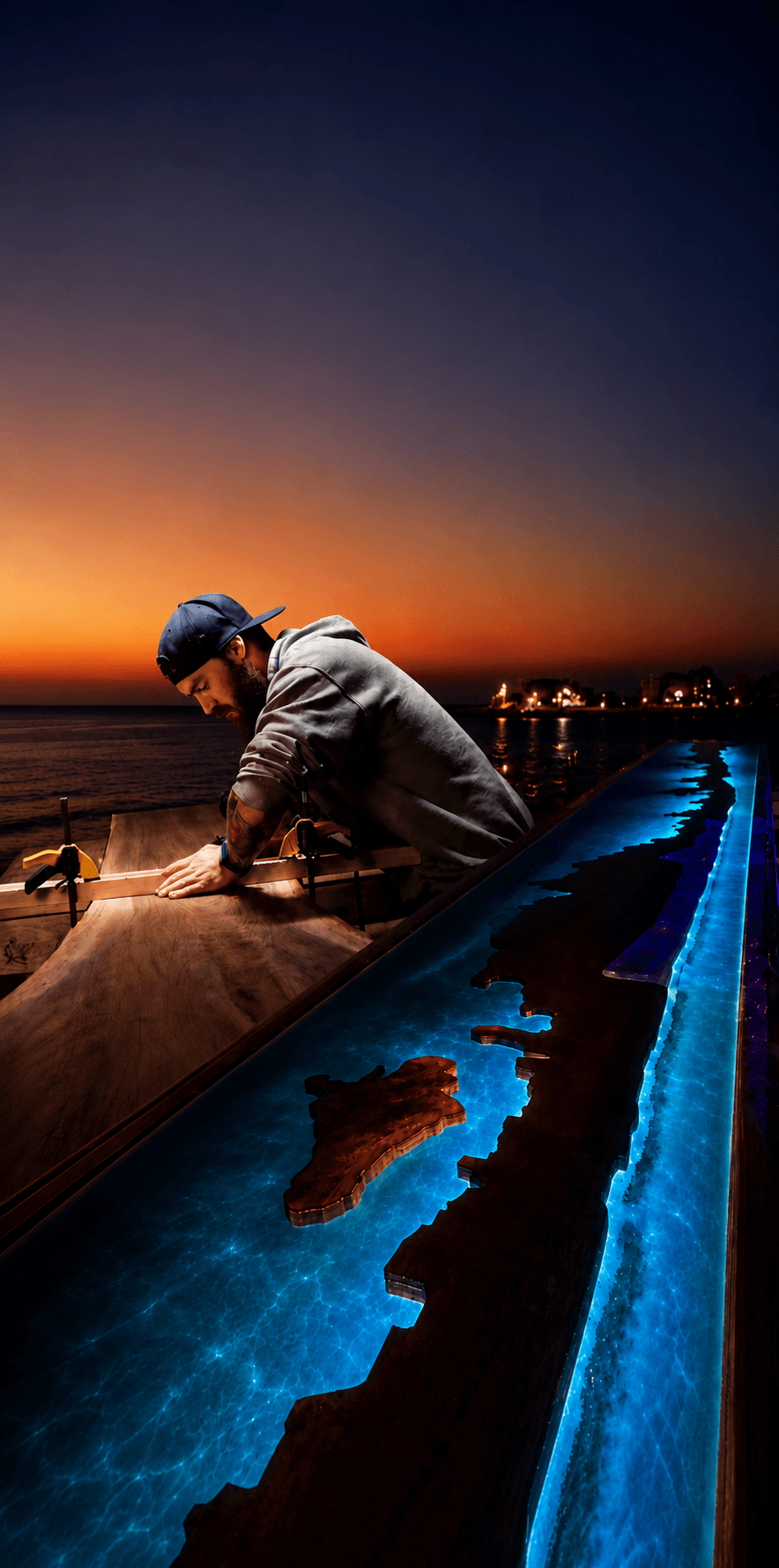 Live edge bar top glowing teal over the bay at night