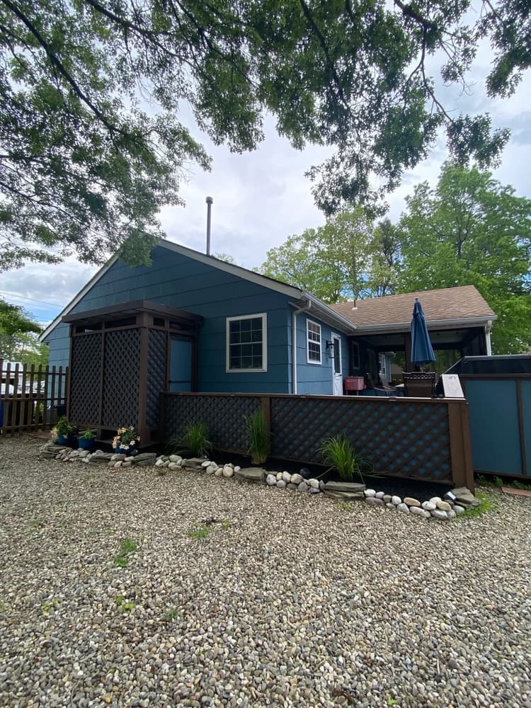 Full exterior home renovation with lattice deck and fresh paint