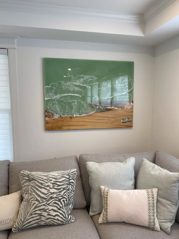 Ocean wave resin wall art hanging above living room couch