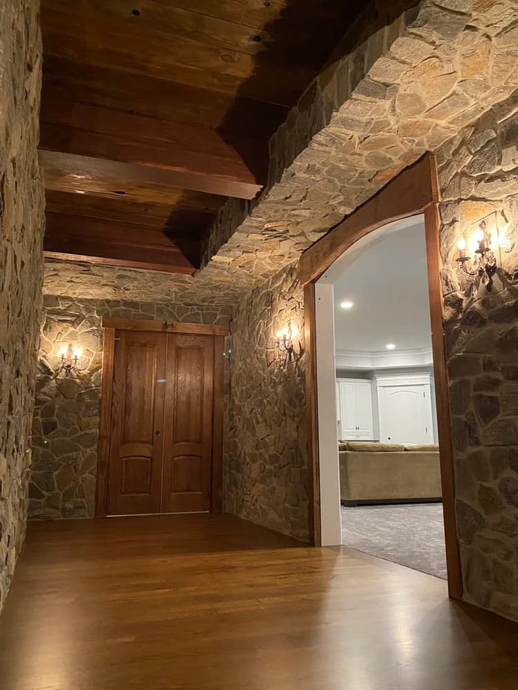Stone archway interior with reclaimed wood ceiling beams