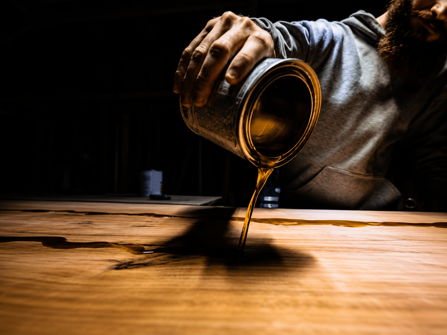 Pouring finish oil onto a live edge slab